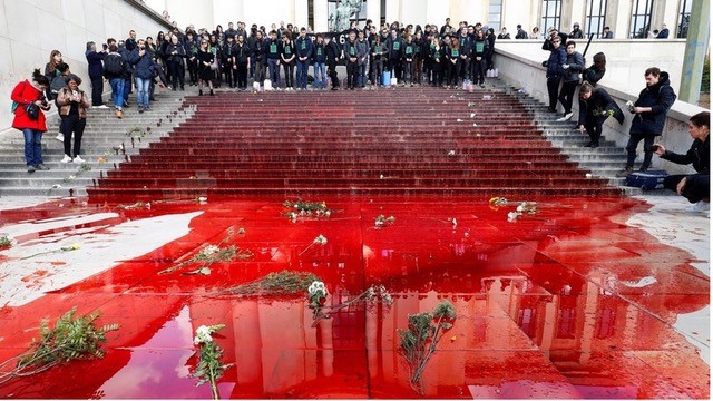 Extinction Rebellion pours fake blood on the steps of the Trocadero in Paris in 2019.