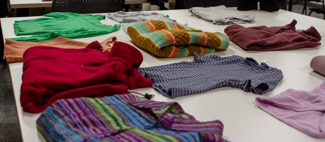 Clothes are folded on a table at a Patchwork Initiative and SSC Clothing Swap at the Nancy Richards Design Center on April 10.