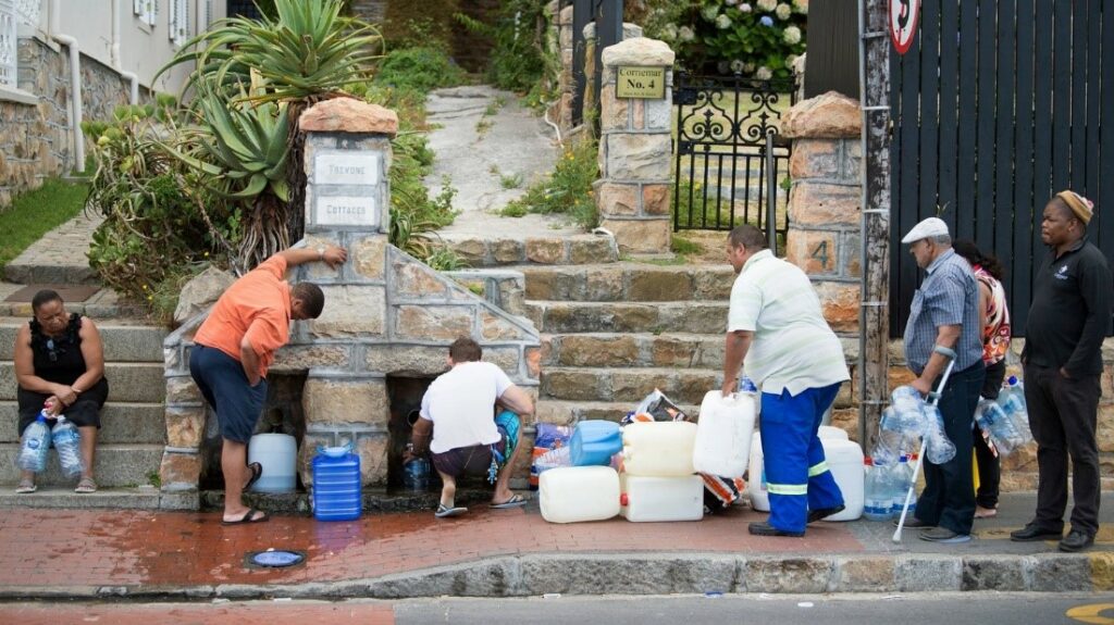 People in Cape town retrieving water at a public water tap