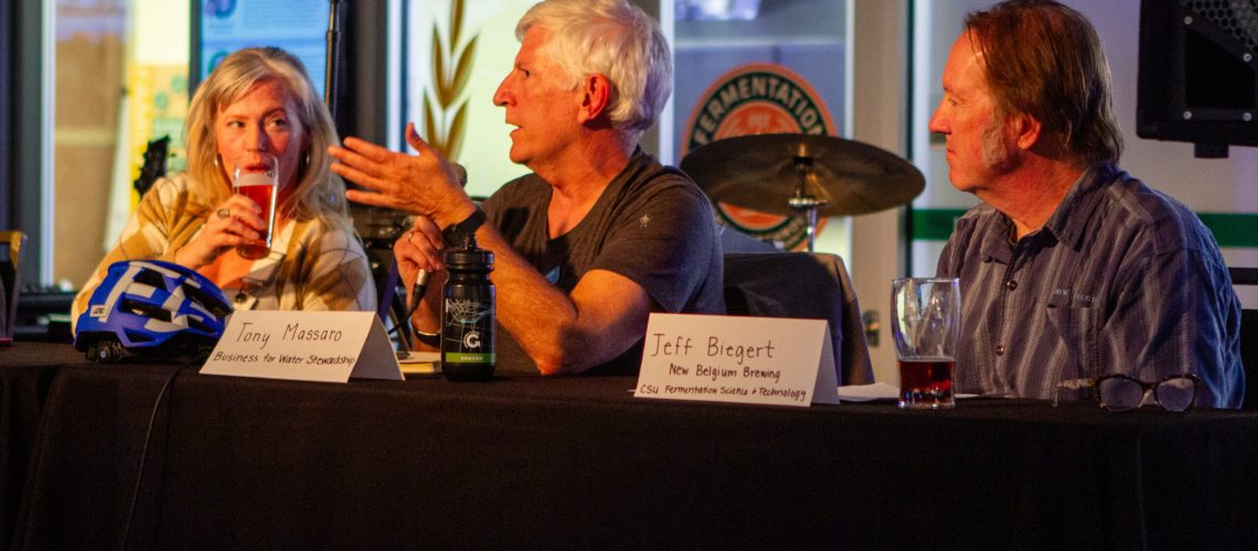 Three people sit at a table.