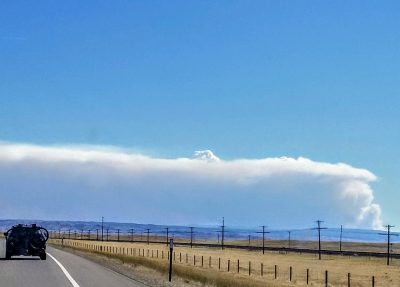 Smoke cloud from the Cameron Peak wildfire in Colorado. Wildfires are extreme events that visibly degrade air quality.