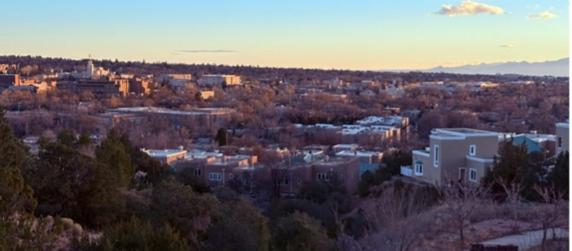 View of downtown Santa Fe from nearby hill at sunset